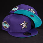 Two DAY N HOU Rushmore WS05 Purple Teal Houston Astros 5950 Fitted New Era Hats feature a large star and "H" logo, teal brims and under-brims; one displays a World Series patch. Both are set against a black background.