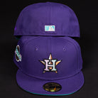 Two DAY N HOU Rushmore WS05 Purple Teal Houston Astros New Era 5950 Fitted hats are displayed. The front has the Astros star H logo and a side patch, the back features the MLB logo. Both hats appear against a black background.