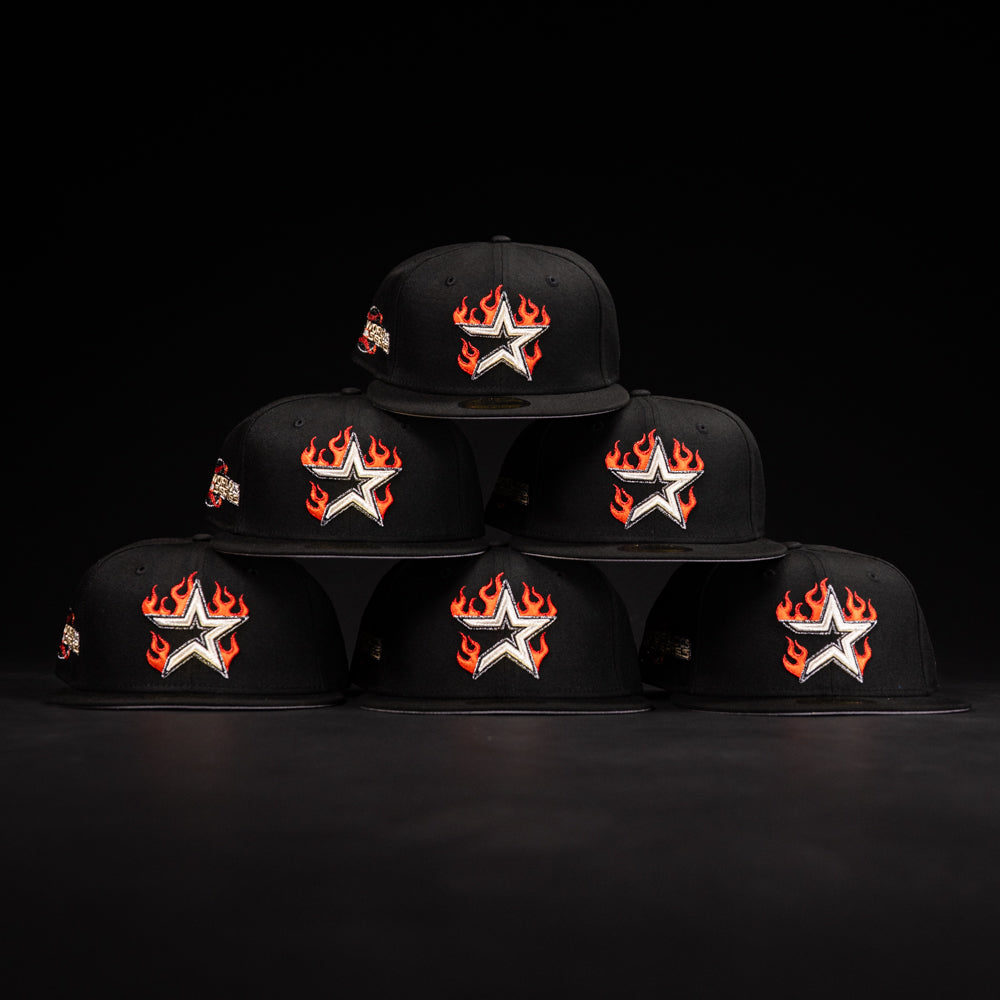 Six La Flame Rushmore WS05 Fire Black Houston Astros New Era Hat 5950 Fitted caps are stacked in a pyramid. Each features a silver star with red flames and white outline above the brim, set against a dark background.