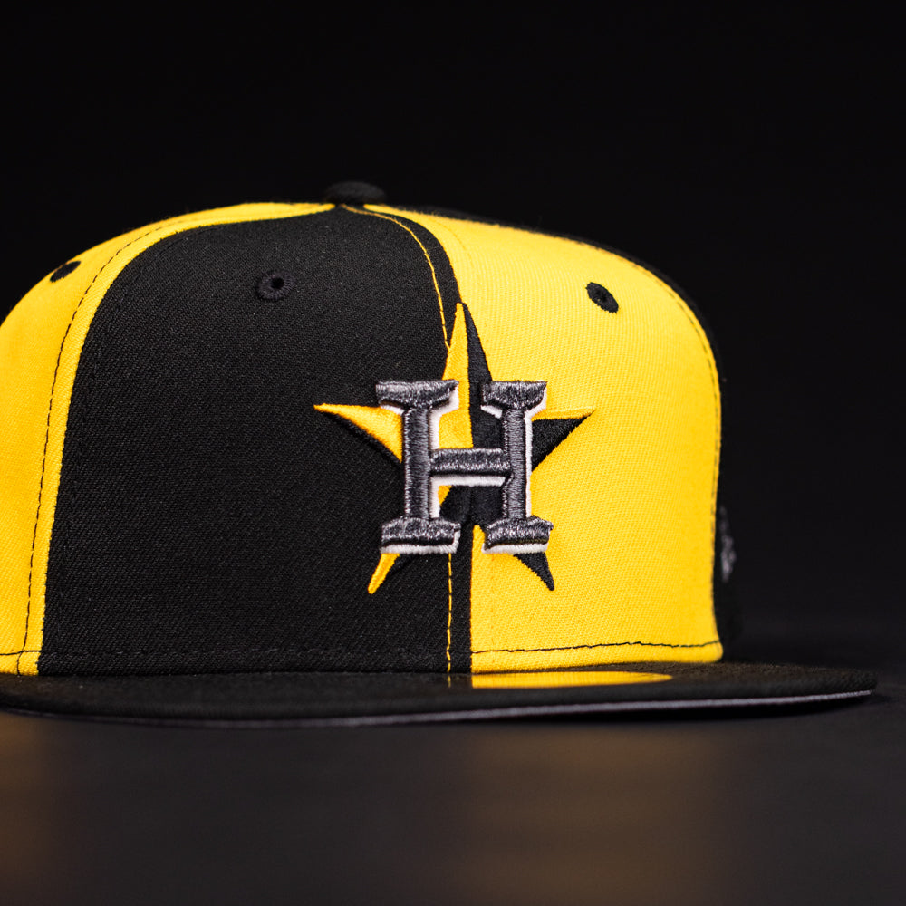 The Hazmat Rushmore Gold Black Pinwheel Houston Astros New Era 5950 Fitted Hat features a split black and yellow design with a large embroidered H and star logo on the front.