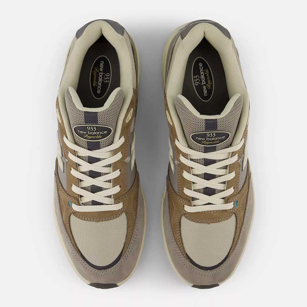 Top-down view of 933 GRY Andrew Reynolds Gray Day New Balance Numeric suede skateboarding shoes in gray, with premium cushioning, white laces, mesh and suede panels, plus black tongue labels showing the brand and model name.