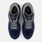 A pair of New Balance Numeric 933 LNV Navy Slate Gray Andrew Reynolds suede skateboarding shoes, featuring gray laces and trim and viewed from above on a white background, showcases a heritage-inspired design complemented by premium cushioning for all-day comfort.
