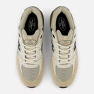 A top view of a pair of Quicksand and Sea Salt Gray Andrew Reynolds New Balance Numeric 933 ONE suede skateboarding shoes, featuring gray side logos and white laces, placed side by side on a white background to highlight their heritage design and premium cushioning.