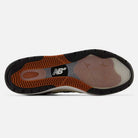 The image displays the sole of the 933 LNV Navy Slate Gray Andrew Reynolds New Balance Numeric Suede Skateboarding Shoes, featuring a combination of black, orange, and translucent rubber with the New Balance logo prominently positioned in the center. Drawing inspiration from Andrew Reynolds’ iconic skate shoes, this model incorporates an ABZORB midsole to deliver exceptional cushioning and comfort.