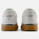 Rear view of 933 WWB White Black Andrew Reynolds New Balance Numeric Suede Skateboarding Shoes with gum soles, displaying the New Balance logo on the heels against a plain white background.