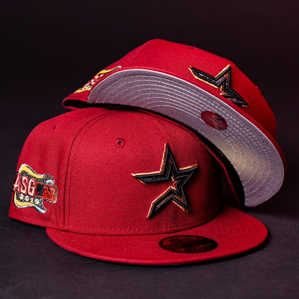 Two ASG19 Bred Houston Astros New Era Hat 5950 Fitted caps in red, featuring a star logo—one flat and one stacked to display both the top and underside of the brim, ideal for any Astros fan.