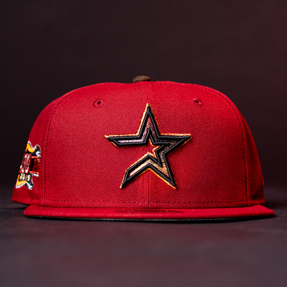 The ASG19 Bred Houston Astros New Era 5950 Fitted Hat features a black and gold star logo on the front, a colorful side patch, and comes in red.