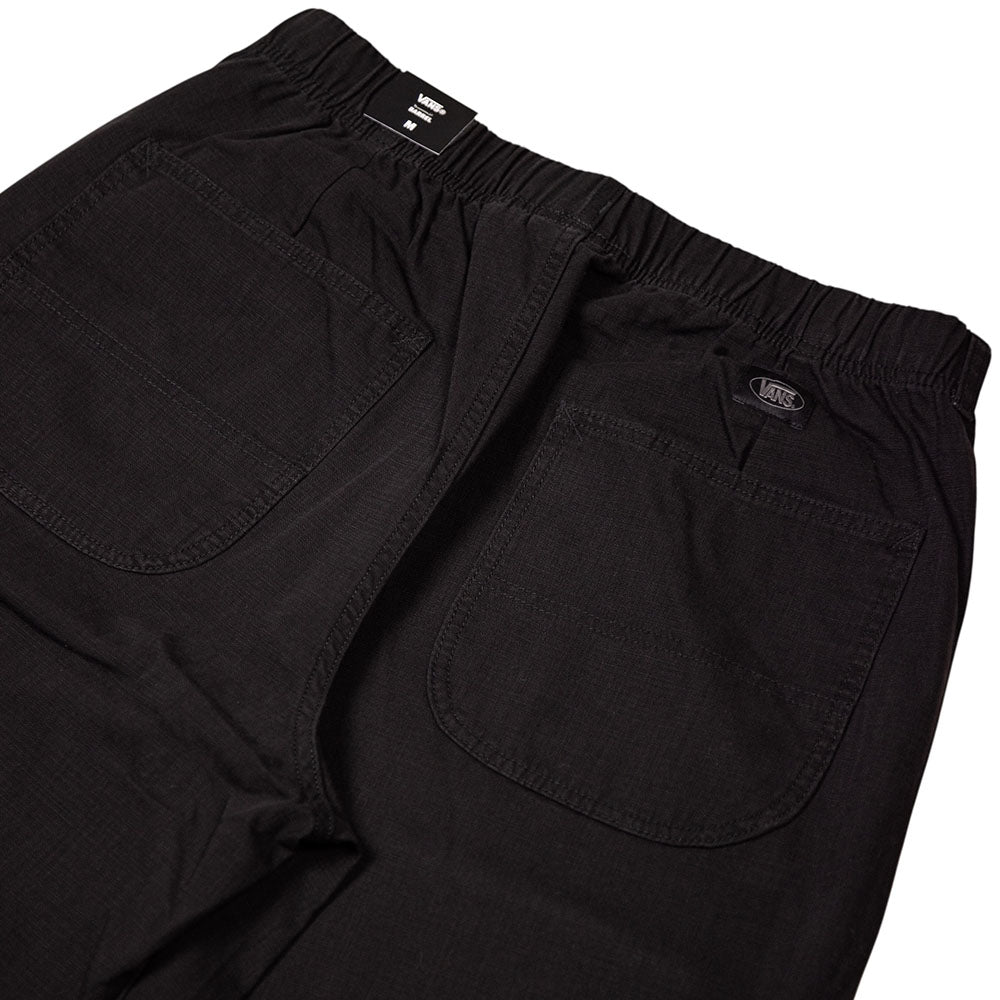 Close-up of the back of the Vans Addison Barrel Black VN0010HYBLK Pants, showcasing two spacious rear pockets and an elastic waistband. Made from durable micro ripstop fabric, these loose-fit pants are finished with the signature Vans logo above the right pocket.