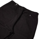 Close-up of the back of the Vans Addison Barrel Black VN0010HYBLK Pants, showcasing two spacious rear pockets and an elastic waistband. Made from durable micro ripstop fabric, these loose-fit pants are finished with the signature Vans logo above the right pocket.