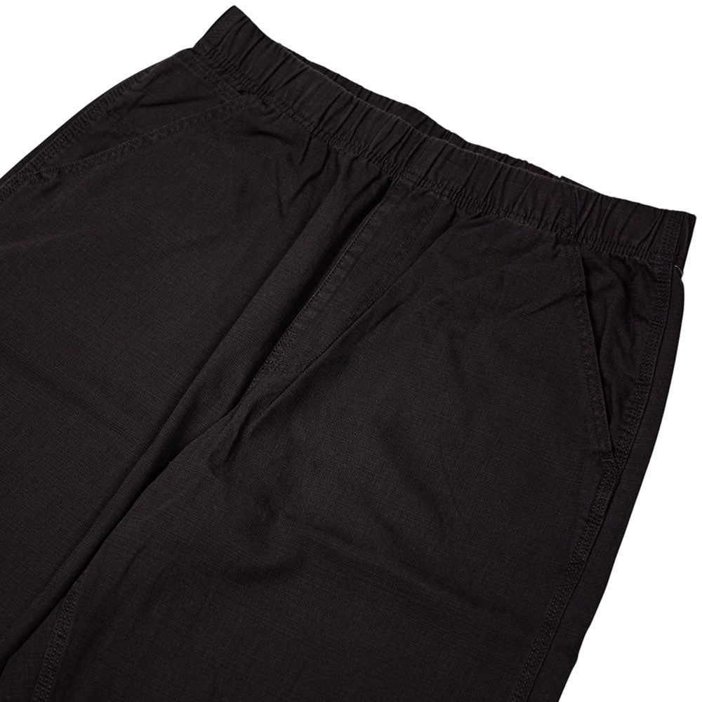The Vans Addison Barrel Black VN0010HYBLK Pants showcase a loose fit with an elastic waistband and side pockets, crafted from durable micro ripstop fabric and displayed against a white background.