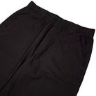 The Vans Addison Barrel Black VN0010HYBLK Pants showcase a loose fit with an elastic waistband and side pockets, crafted from durable micro ripstop fabric and displayed against a white background.