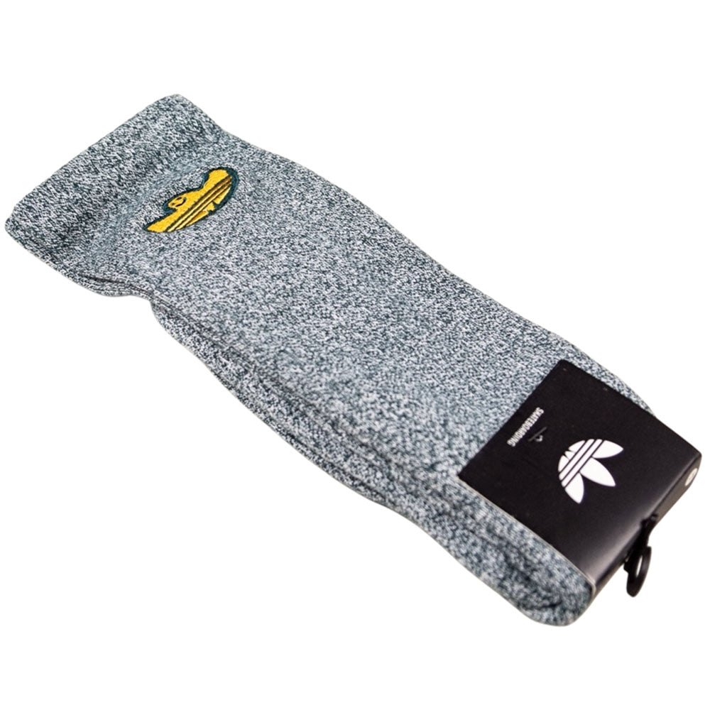 A pair of Adidas Skateboarding Gonz Art Sock KD3674 in gray heather, shown in packaging with a white Adidas logo on the label and a yellow logo on the sock.