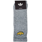 The Adidas Gonz Art Sock KD3674 is a gray skateboarding sock featuring a small yellow embroidered taco graphic and comes packaged with a black and white Adidas logo.