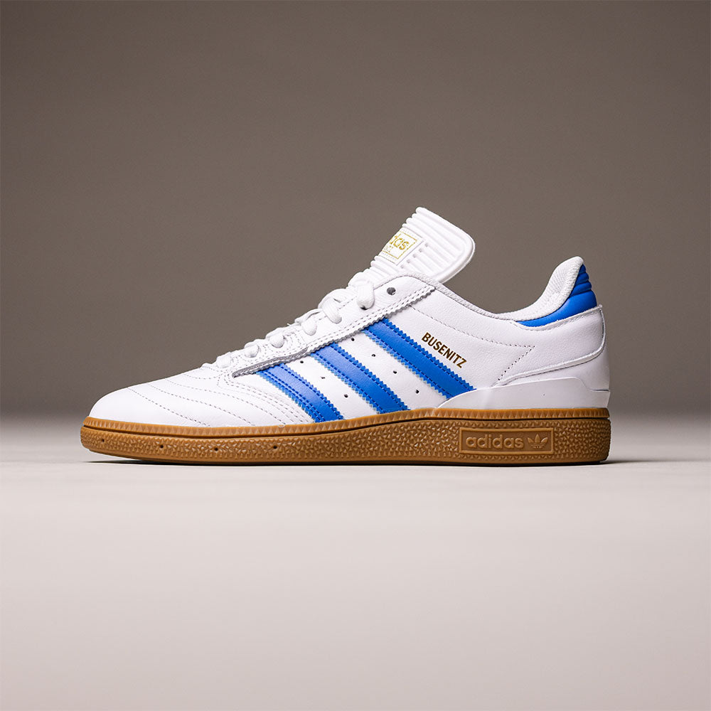 The Busenitz Blue White Gum IE3101 Adidas Skateboarding Leather Shoes are featured on a plain background, showcasing their white leather upper with blue stripes, brown gum sole, and 'BUSENITZ' in gold on the side—these classic adidas skate shoes combine timeless style with durable performance for skateboarding.