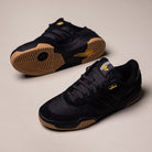 The KJ5054 Cordura Carbon Black Tekkira Cup Adidas Skateboarding Suede Shoes feature gum soles, yellow accents, and textured details, displayed on a light beige background.