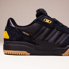 The KJ5054 Cordura Carbon Black Tekkira Cup Adidas Skateboarding shoe has a suede upper with mesh details, yellow heel and eyelet accents, signature black stripes, gum rubber sole, and durable CORDURA branding near the heel.