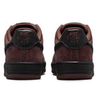 Back view of the Air Force 1 Black Light Chocolate HM8517201 Nike SB Suede Skateboarding Shoes in brown, featuring black soles and NIKE SB AIR text stitched in red on the heels, set against a white background and offering responsive Nike Air cushioning for all-day comfort.
