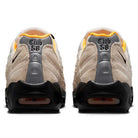 Rear view of a pair of Air Max 95 Sail Black Laser Orange Nike SB skateboarding shoes, featuring beige and gray tones, black soles, orange inner lining, and Club 58 stitched in black on the heel area.