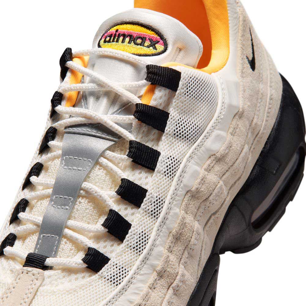 Close-up of the Air Max 95 Sail Black Laser Orange Nike SB Skateboarding Shoes (IQ8395100), featuring white and beige tones, black accents, orange inner lining, visible air unit in the sole, and a colorful Air Max logo patch on the tongue.