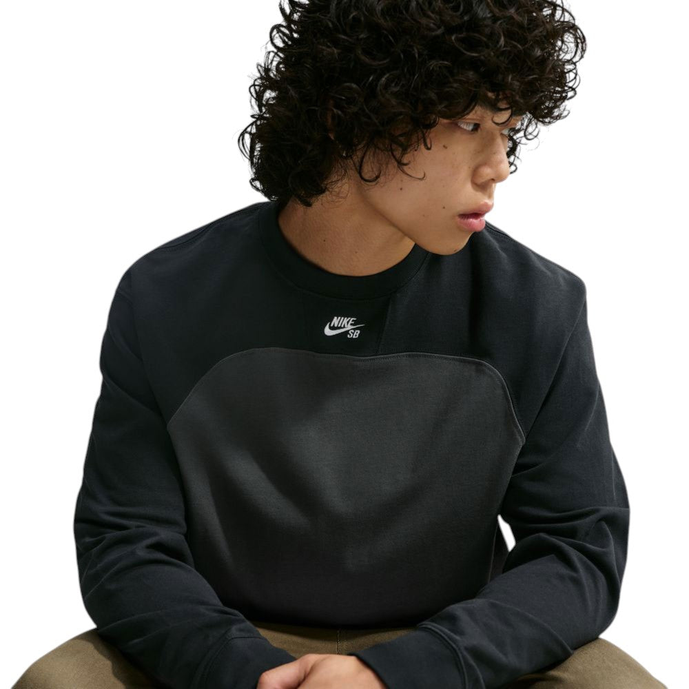 A person wears a black and gray Airmail Longsleeve IM5430060 Black Gray Skate Longsleeve T-Shirt SB Tee Skate Nike SB Skateboarding, featuring a laid-back crewneck design with a small logo on the chest for durable comfort.