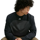A person wears a black and gray Airmail Longsleeve IM5430060 Black Gray Skate Longsleeve T-Shirt SB Tee Skate Nike SB Skateboarding, featuring a laid-back crewneck design with a small logo on the chest for durable comfort.