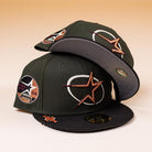 Two GWOP Dark Green Burgundy Bronze Circle Star Houston Astros New Era Hat 5950 Day caps, featuring star and circular embroidery, are stacked together on a gradient beige background.