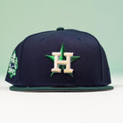 The Creator Pack Navy Green Houston Astros New Era Hat 5950 Fitted features a navy fitted design, green brim and grommets, a green star with cream "H" logo on the front, and a World Series patch on the left side.