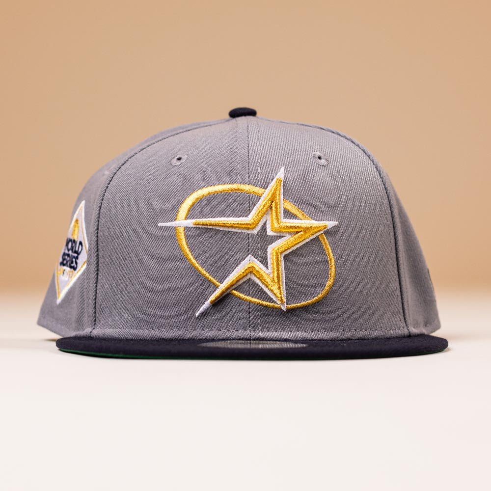 The Gray Navy Circle Star Houston Astros New Era 5950 Fitted Hat features a bold star logo and side patch, making it perfect for batting practice or casual wear.