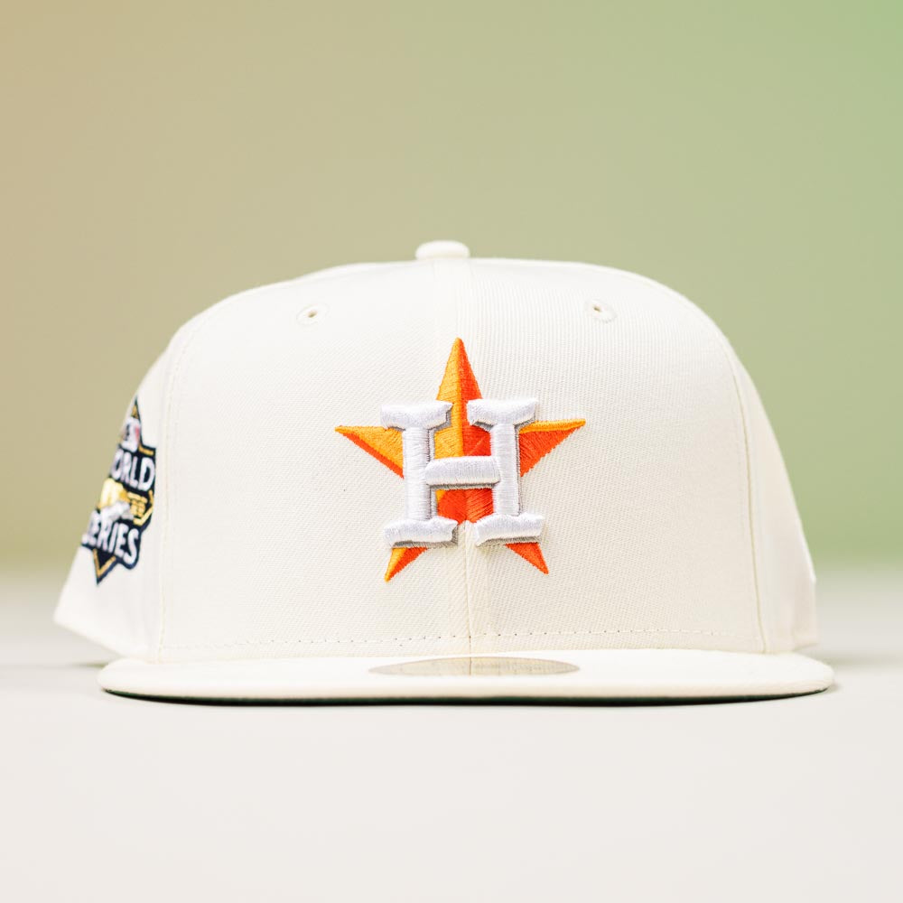 The Summer Days 2022 Houston Astros New Era Hat 5950 Day features the team’s logo with an orange star and white H on the front, a 2022 World Series patch on the side, and comes in white.