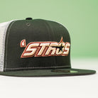 A black and white mesh El Jimador Stone Houston Astros New Era 5950 Fitted hat featuring "STROS" in orange/yellow embroidery with a star on a green background—perfect for Whatafitted style fans.