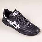 The Leggerezza Asics Black Bright White 1201B045 leather skateboarding shoes feature a black upper with white side stripes, a white ASICS logo on the tongue, black laces, and a sleek design inspired by classic Asics soccer cleats.