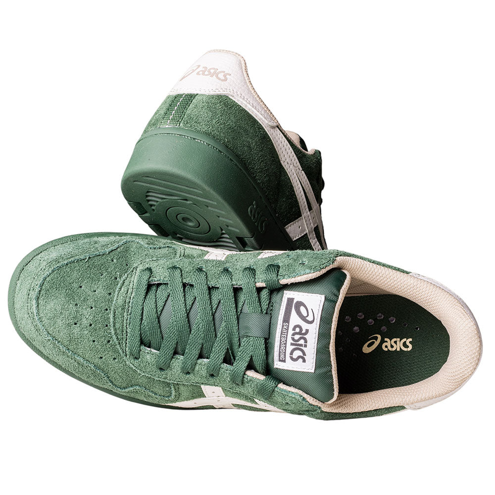 A pair of Japan Pro Asics Forest Night Cream 1201A920300 suede skateboarding shoes in green with white accents and beige lining, shown from above and the side, featuring the brand logo on the tongue and heel.