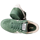 A pair of Japan Pro Asics Forest Night Cream 1201A920300 suede skateboarding shoes in green with white accents and beige lining, shown from above and the side, featuring the brand logo on the tongue and heel.