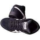 A pair of Japan Pro MT Asics Black Bright White 1201B003003 suede skateboarding shoes—high-top with white side stripes, black laces, and a white logo on the tongue. One stands upright while the other is tipped to show the sole.