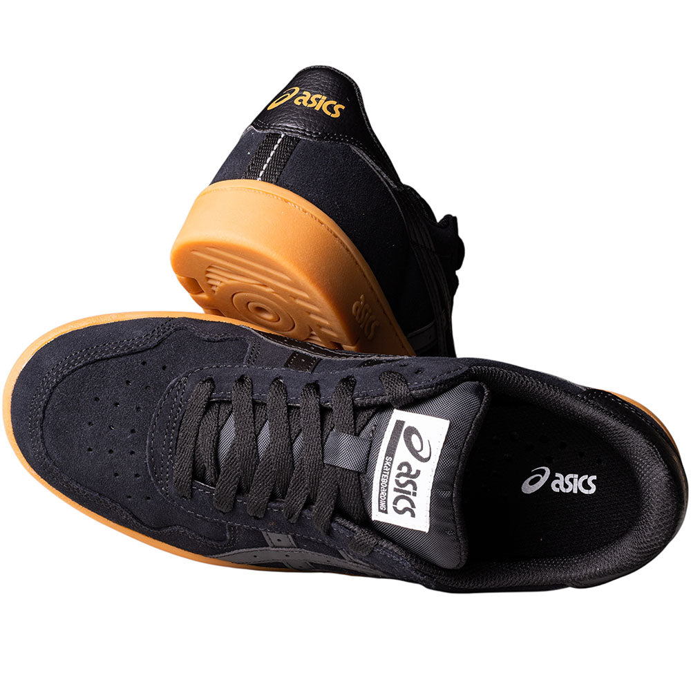 A pair of ASICS Japan Pro Black Tan Presido 1201A920003 suede skateboarding shoes, one upright and one on its side, display logos on the tongue and insole.