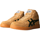 The Japan Pro MT Asics Walnut Forest Night 1201B033200 suede skateboarding shoes feature a tan mid-top design with brown soles and dark green Asics stripes, displayed at an angle on a white background.
