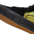 Close-up of Atiba Vans Sk8 HI Black Multi VN0A5FCCBOV Suede Skateboarding Shoes featuring a yellow patterned side panel, a black midsole embossed with DuraCap technology, and a gum-colored waffle tread sole.