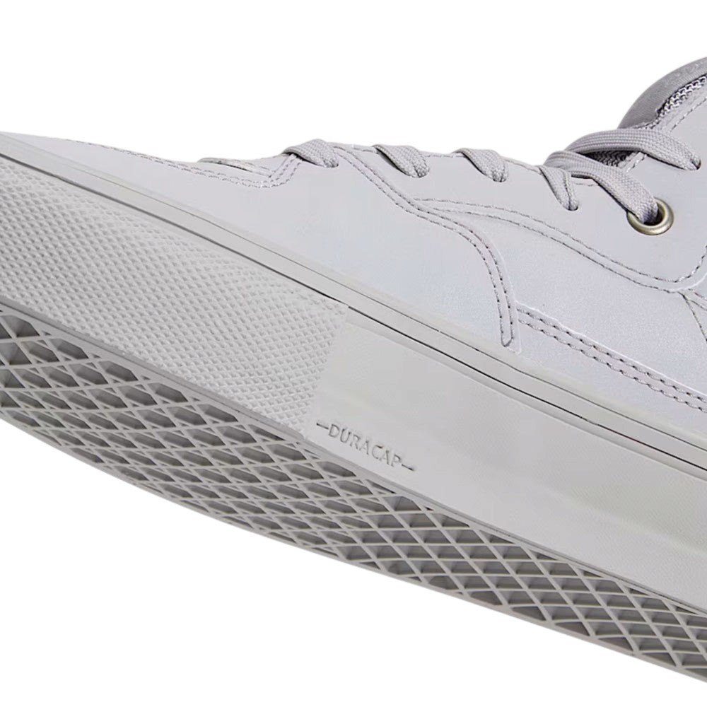 Close-up of a light gray Atiba Vans Skate Half Cab Light Gray VN0A5FCDBH71 Suede Skateboarding Shoe with a textured rubber toe bumper and Duracap branding on the side of the sole.