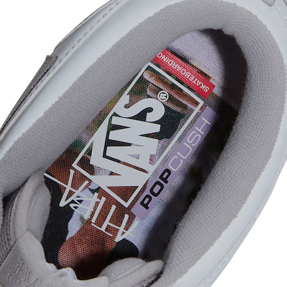 Close-up of the interior of a light gray Atiba Vans Skate Half Cab Light Gray VN0A5FCDBH71 Suede Skateboarding Shoe, showing the branded insole with a camouflage pattern.
