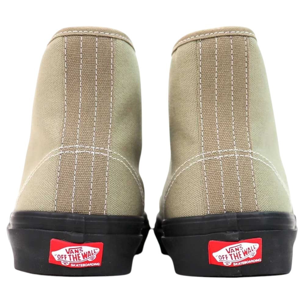 A pair of Authentic High Elm Black VN000CBQEL7 Vans Skate Canvas Rubber Shoes viewed from the back, showcasing white stitching and red Vans Off The Wall skateboarding logos above black soles. These durable shoes feature classic skate design details, making them ideal for everyday wear.