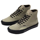A pair of Authentic High Elm Black VN000CBQEL7 Vans skateboarding shoes made from light brown canvas with black laces and black rubber soles, displayed on a white background.