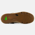 The image shows the bottom view of the Baked Clay Black 1010 LV New Balance Numeric suede skateboarding shoe sole with a wavy tread, black NB logo at the center, and a green accent near the heel.