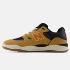 The Baked Clay Black 1010 LV New Balance Numeric Suede Skateboarding Shoes feature mustard yellow and black suede and mesh panels, white laces, and an orange N logo, displayed in a side profile against a plain white background.