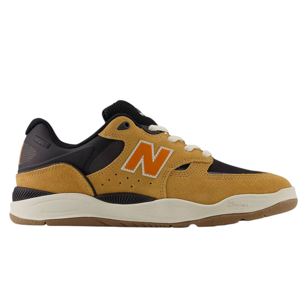 Side view of the Baked Clay Black 1010 LV New Balance Numeric Suede Skateboarding Shoe featuring a mustard yellow (baked clay) and black colorway, an orange N logo, white laces, and a beige sole, set against a white background.