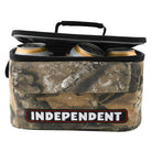 A Bar Logo 5 Liter Independent x Realtree Cooler Unisex, featuring a camo-patterned exterior and an INDEPENDENT patch, is shown with its lid open to reveal several canned beverages inside.