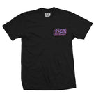 The Bat Egg Black Heroin Skateboards Tee features purple and white graffiti-style HEROIN SKATEBOARDS text on the left chest and inside the collar, finished with a subtle signature Bat Egg detail.