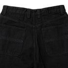 Close-up of the back of Bighead Fill Denim Pant Black Spitfire Wheels, featuring two back pockets with subtle wavy stitching and belt loops on the waistband.
