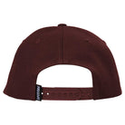 The Bighead Fill Hat Dark Red Red Snapback from Spitfire Wheels is shown from the back, featuring an adjustable strap and a small black tag with white SPITFIRE lettering.