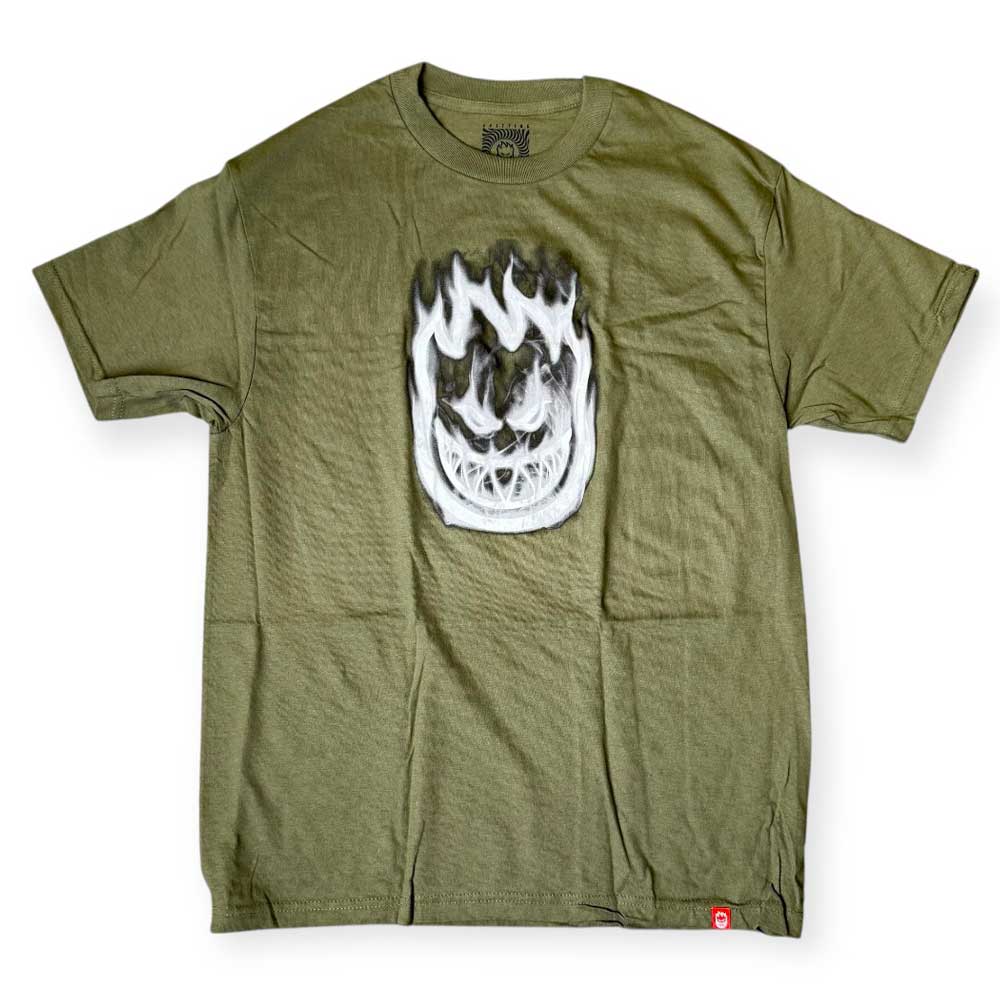 The Bighead Smoke Military Green White Tee by Spitfire Wheels features a bold white flame Bighead Smoke graphic with a smiling face on the front, classic crew neck, and short sleeves in military green.