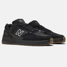 The Black 933 NAP New Balance Numeric Suede Skateboarding Shoes feature suede and mesh uppers, white outlined N logos on the sides, and brown rubber outsoles, shown on a plain light background.